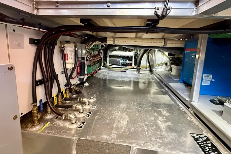 Slide: The Image of Engine room of a 2015 Coastal Craft 45 yacht, showcasing wiring and mechanical components. - 86