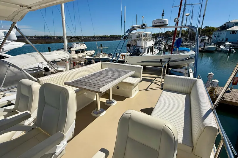 Slide: The Image of Luxurious 2015 Coastal Craft 45 yacht with spacious seating and dining area in a marina. - 28