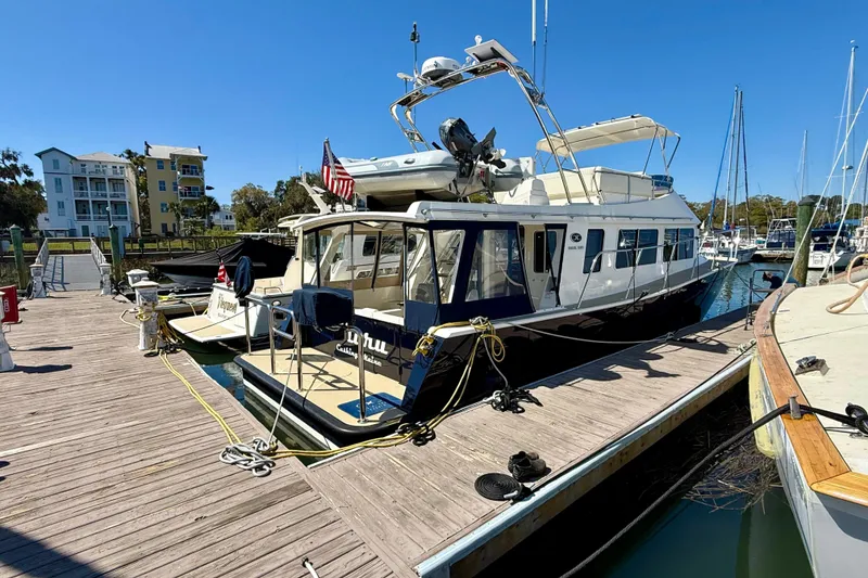 Slide: The Image of 2015 Coastal Craft 45 yacht docked at a marina under clear blue skies. - 17