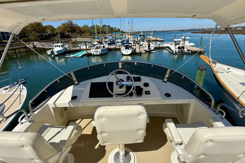 Slide: The Image of Flybridge view of 2015 Coastal Craft 45 yacht docked at a marina. - 25