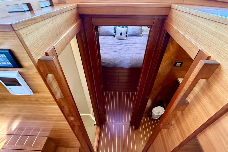 Slide: The Image of Interior view of 2015 Coastal Craft 45 yacht, featuring wooden finishes and cozy bedroom. - 55