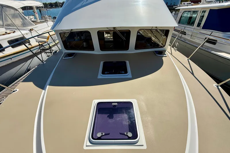Slide: The Image of 2015 Coastal Craft 45 yacht deck with hatches, docked at marina. - 19