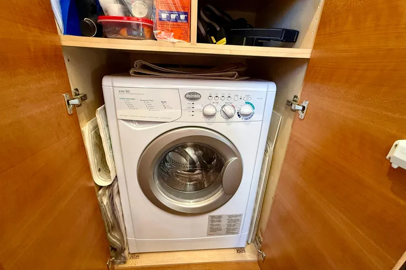 Slide: The Image of Compact washing machine inside a wooden cabinet on a 2015 Coastal Craft 45 boat. - 68