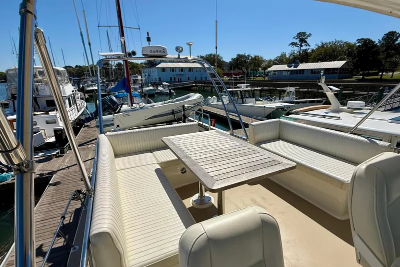 Slide: The Image of Coastal Craft 45 yacht, 2015 model, featuring a spacious outdoor seating area at the marina. - 29