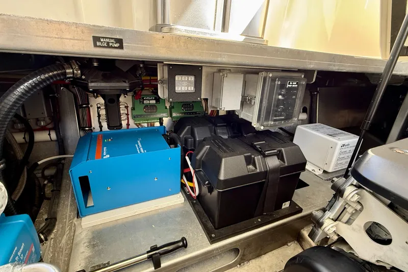 Slide: The Image of Engine room of 2015 Coastal Craft 45 with electrical components and manual bilge pump. - 73
