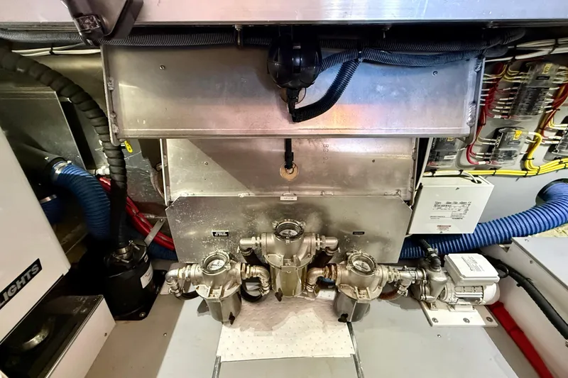 Slide: The Image of Engine room of a 2015 Coastal Craft 45 yacht, showcasing mechanical components and wiring. - 83
