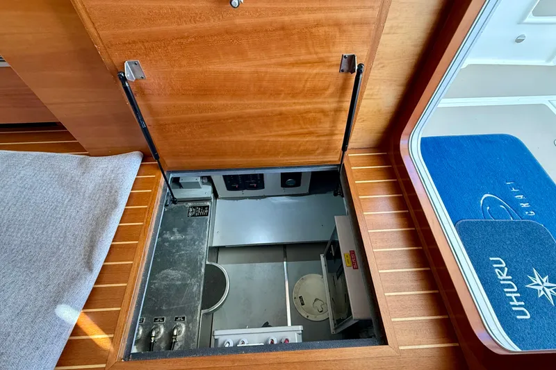 Slide: The Image of Engine room access hatch on 2015 Coastal Craft 45 yacht, featuring wooden flooring and interior details. - 84