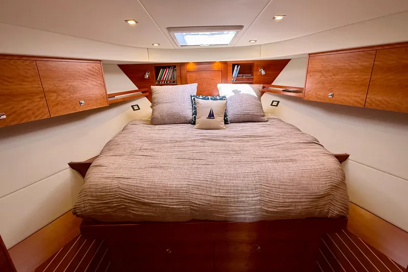 Slide: The Image of Luxurious cabin interior of 2015 Coastal Craft 45 yacht with cozy bedding and wooden cabinetry. - 59