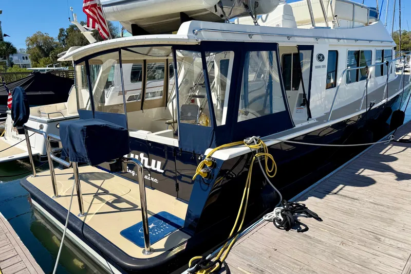 Slide: The Image of 2015 Coastal Craft 45 yacht docked, featuring sleek design and spacious deck. - 15