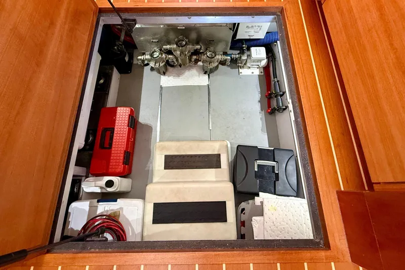 Slide: The Image of Engine compartment of a 2015 Coastal Craft 45 yacht, showcasing organized equipment and storage. - 78