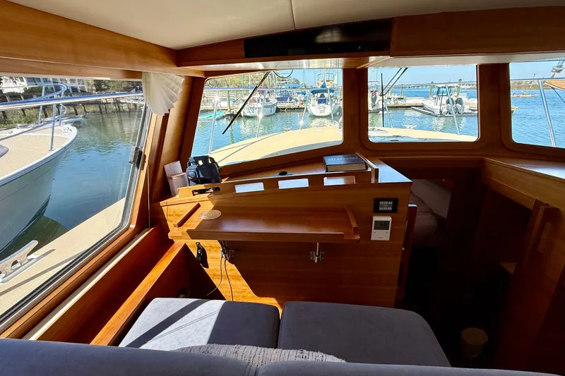 Slide: The Image of Interior view of 2015 Coastal Craft 45 yacht with marina in background. - 54