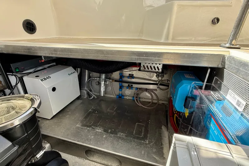 Slide: The Image of Engine compartment of a 2015 Coastal Craft 45 boat, showcasing equipment and wiring. - 74