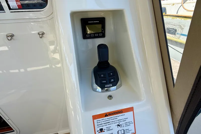 Slide: The Image of Control panel of a 2015 Coastal Craft 45 boat featuring a Volvo Penta joystick. - 40
