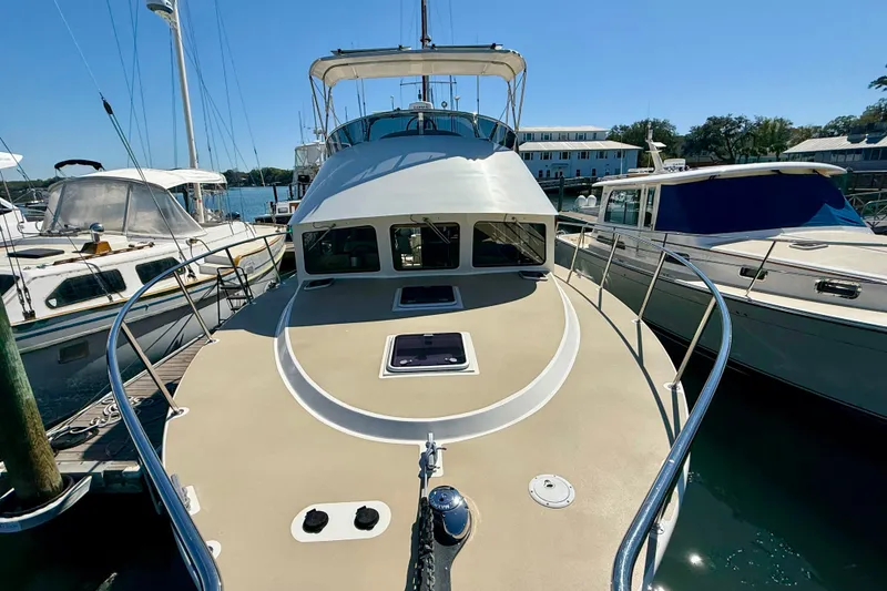 Slide: The Image of 2015 Coastal Craft 45 yacht docked at marina under clear blue sky. - 18