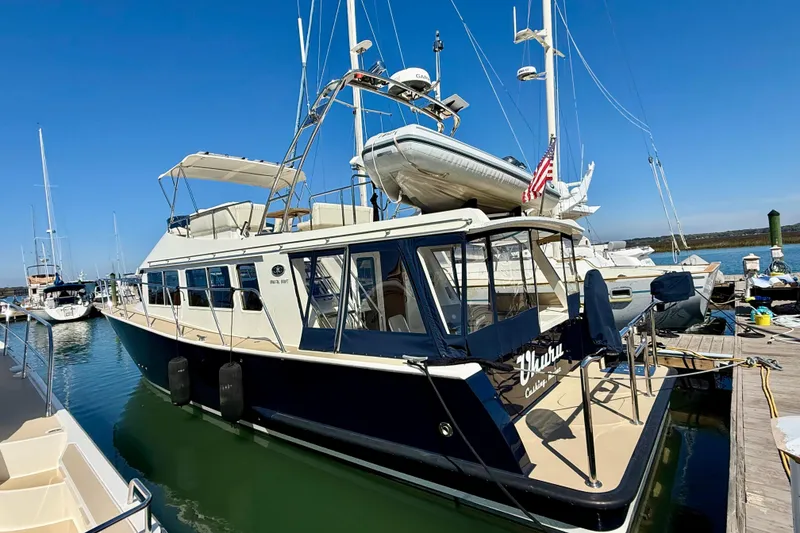 Slide: The Image of 2015 Coastal Craft 45 yacht docked at marina under clear blue sky. - 16