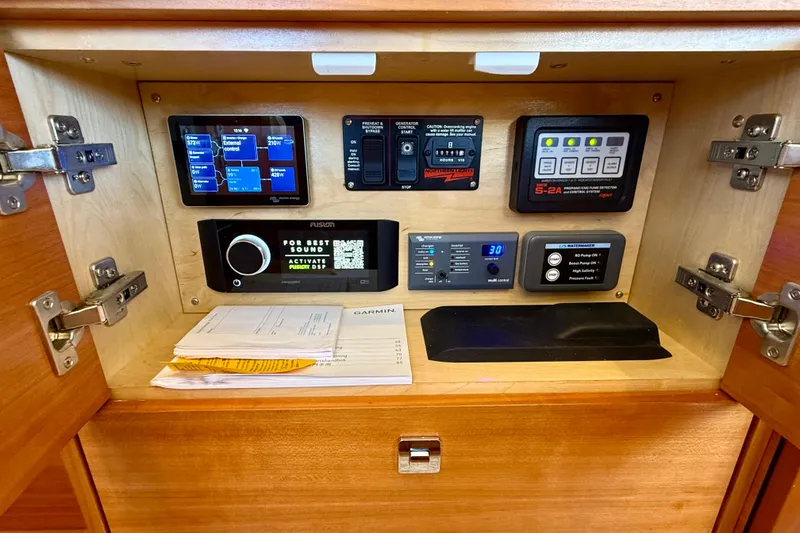 Slide: The Image of Control panel inside a 2015 Coastal Craft 45 yacht, featuring various electronic systems. - 52