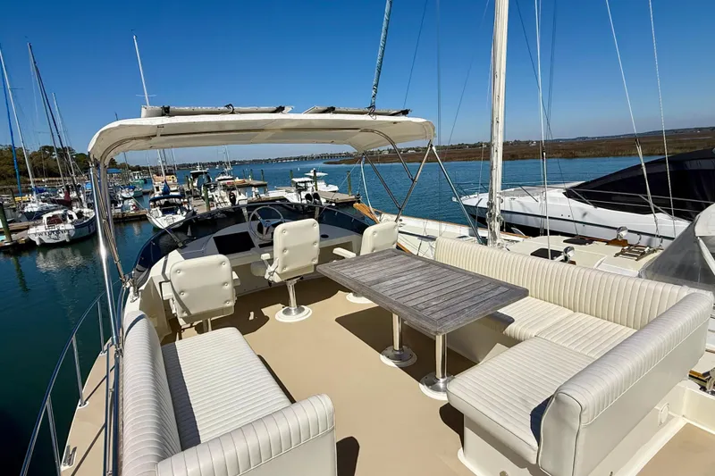 Slide: The Image of Luxury Coastal Craft 45 yacht deck with seating and table, docked at marina, 2015 model. - 30