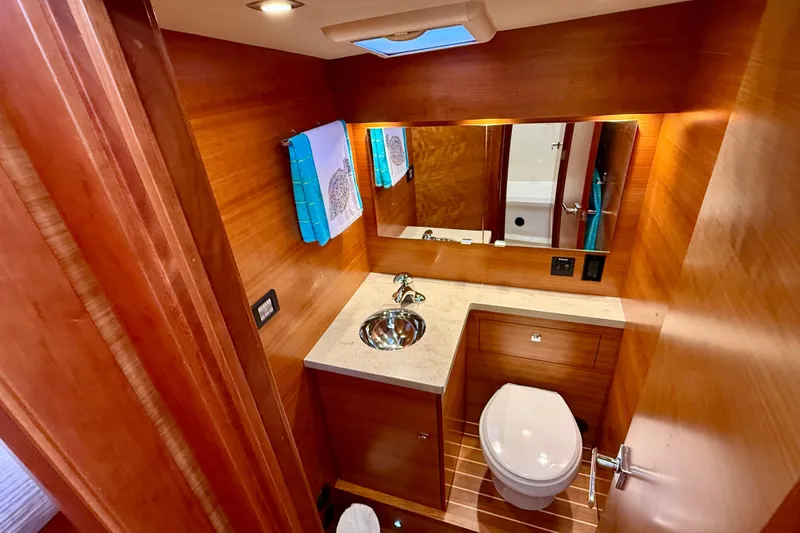 Slide: The Image of Luxurious 2015 Coastal Craft 45 yacht bathroom with wood finish, modern fixtures, and elegant design. - 58