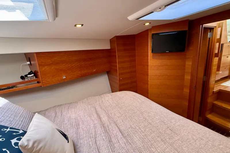 Slide: The Image of Luxurious 2015 Coastal Craft 45 yacht bedroom with wood paneling and modern amenities. - 62