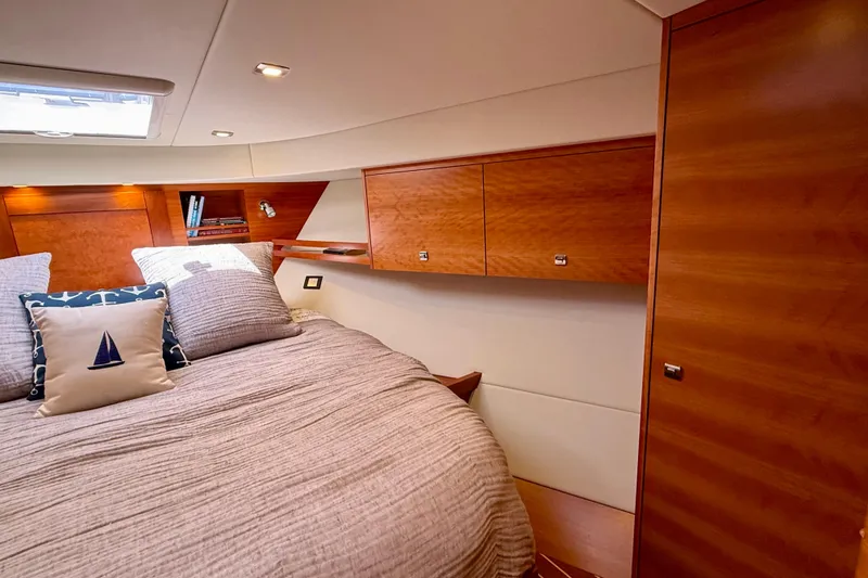 Slide: The Image of Luxurious cabin interior of 2015 Coastal Craft 45 yacht with wooden finishes and cozy bedding. - 61