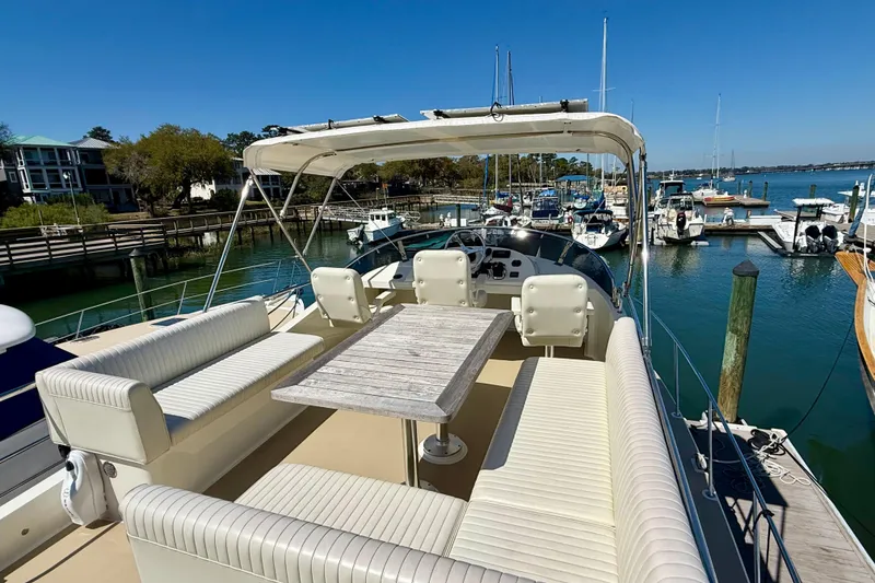 Slide: The Image of 2015 Coastal Craft 45 yacht with spacious deck and seating at marina. - 31