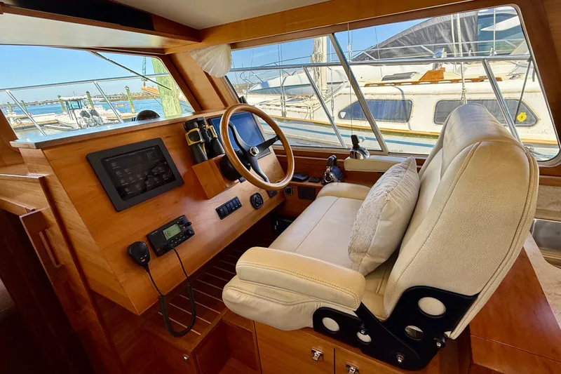 Slide: The Image of Interior helm of 2015 Coastal Craft 45 yacht with leather seat and navigation controls. - 49