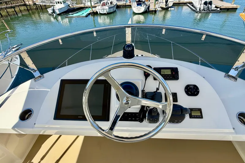 Slide: The Image of Helm of 2015 Coastal Craft 45 yacht with modern navigation equipment and marina view. - 26