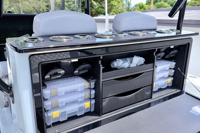 Slide: The Image of 2023 Fountain 34 Tournament Edition boat storage with tackle boxes and cup holders. - 5