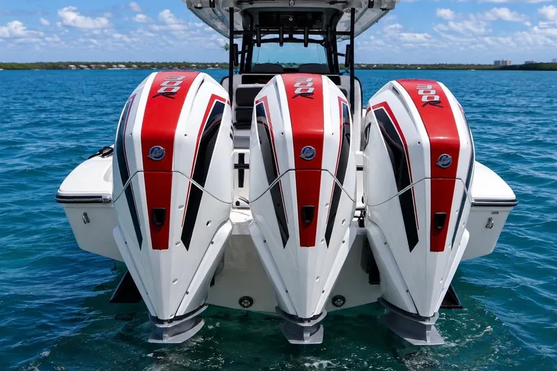 The Image of Triple outboard engines on a 2023 Fountain 34 Tournament Edition boat in blue waters. - 1