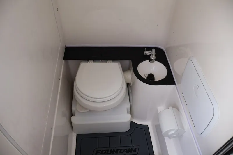 Slide: The Image of 2023 Fountain 34 Tournament Edition boat bathroom with toilet and sink. - 15
