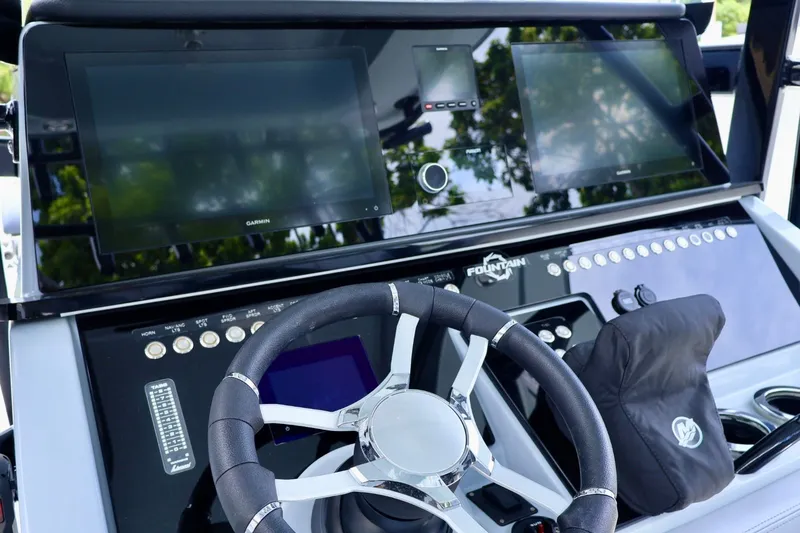 Slide: The Image of 2023 Fountain 34 Tournament Edition boat dashboard with advanced navigation displays and controls. - 7