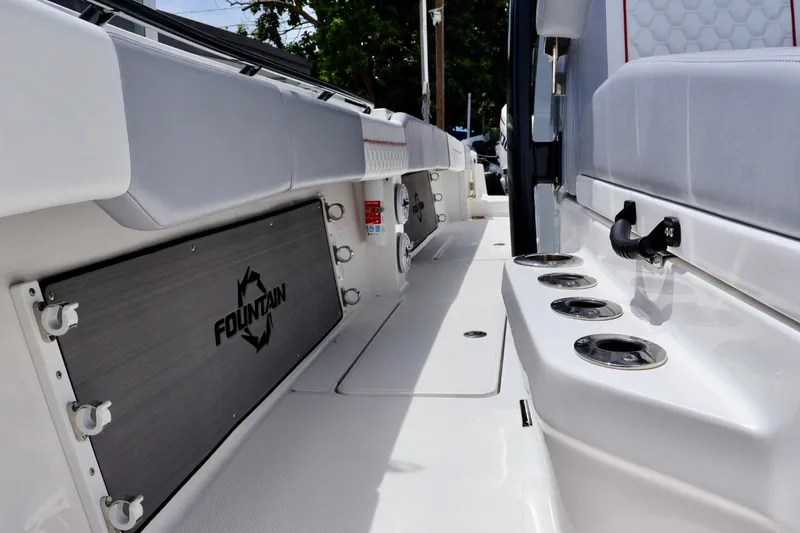 Slide: The Image of 2023 Fountain 34 Tournament Edition boat interior with seating and rod holders. - 12