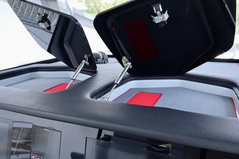 Slide: The Image of 2023 Fountain 34 Tournament Edition boat interior with open hatches and modern dashboard. - 14