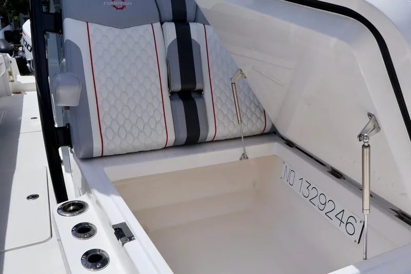 Slide: The Image of 2023 Fountain 34 Tournament Edition boat seat with storage compartment open. - 16