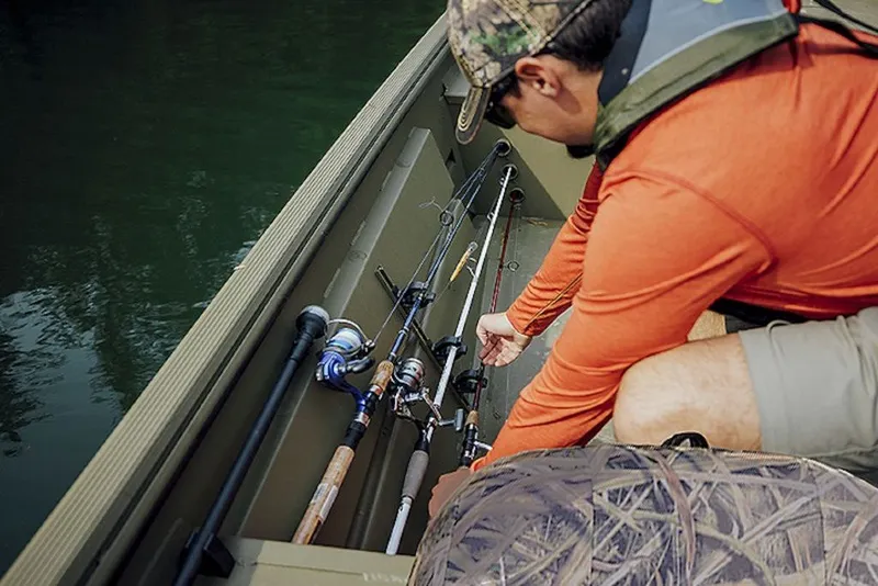 Slide: The Image of Man organizing fishing rods on Lowe Roughneck RX1760 Pathfinder boat, 2027 model. - 7