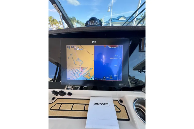 Slide: The Image of Dashboard of 2022 Boston Whaler 280 Vantage with navigation display and Mercury controls. - 23