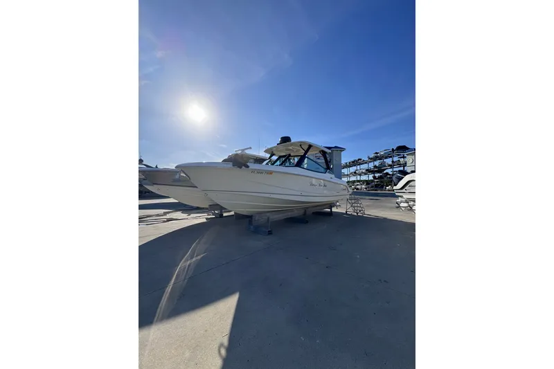 Slide: The Image of 2022 Boston Whaler 280 Vantage boat on dry dock under clear blue sky. - 45