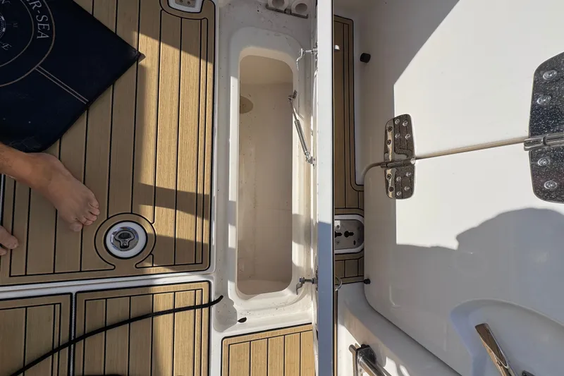 Slide: The Image of Boston Whaler 280 Vantage 2022 boat deck with open storage compartment. - 15