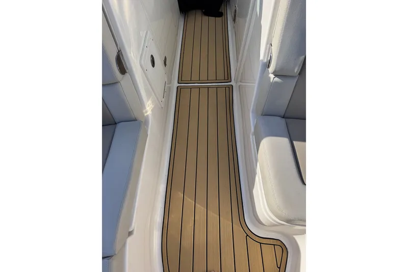 Slide: The Image of Interior view of 2022 Boston Whaler 280 Vantage boat with teak flooring and cushioned seating. - 21