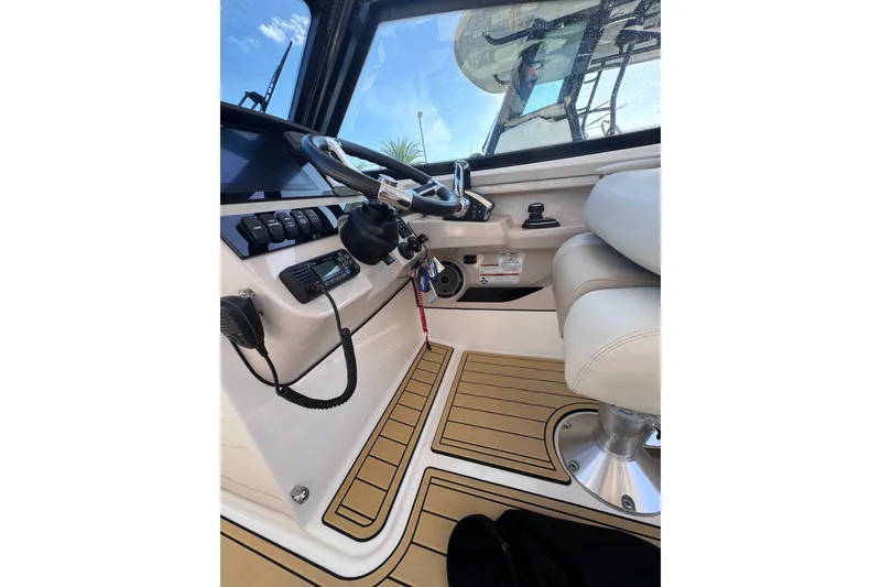 Slide: The Image of Interior view of 2022 Boston Whaler 280 Vantage boat cockpit with steering wheel and controls. - 17