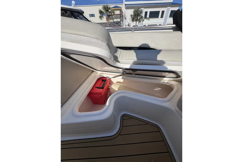 Slide: The Image of Open storage compartment on 2022 Boston Whaler 280 Vantage boat with red container inside. - 13