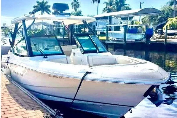 The Image of 2022 Boston Whaler 280 Vantage docked by a sunny waterfront. - 0