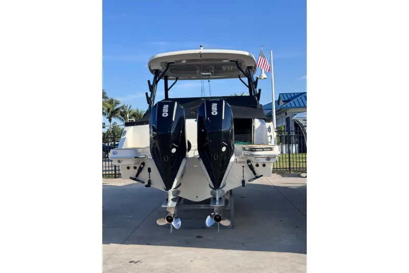 Slide: The Image of 2022 Boston Whaler 280 Vantage boat with dual outboard engines, docked outdoors. - 35