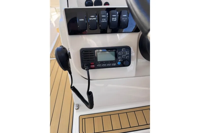 Slide: The Image of Control panel of a 2022 Boston Whaler 280 Vantage boat with radio and switches. - 26