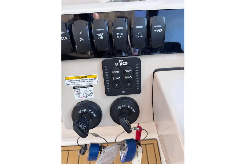 Slide: The Image of Control panel of a 2022 Boston Whaler 280 Vantage boat with switches and keys. - 28