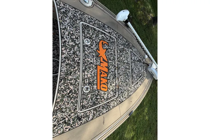 Slide: The Image of 2025 Mako 18 Pro Skiff Backwater Edition with camo deck and orange logo. - 9