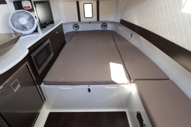 Slide: The Image of Interior cabin of 2021 Edgewater 370CC boat with bed, microwave, and fan. - 58