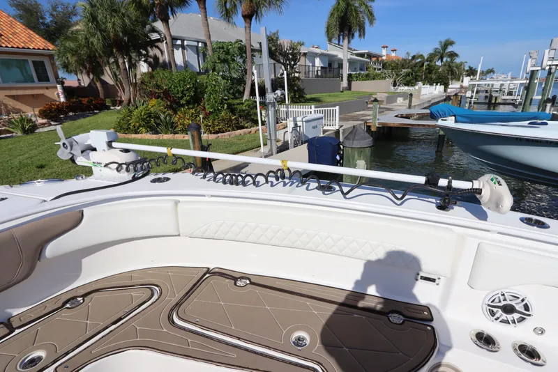 Slide: The Image of 2021 Edgewater 370CC boat docked, featuring spacious deck and modern equipment. - 44