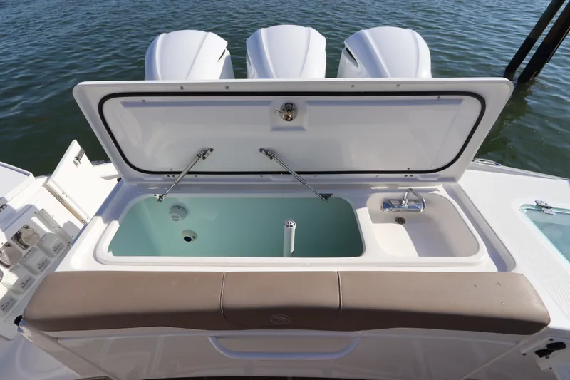 Slide: The Image of Open storage compartment on 2021 Edgewater 370CC boat with triple engines. - 14