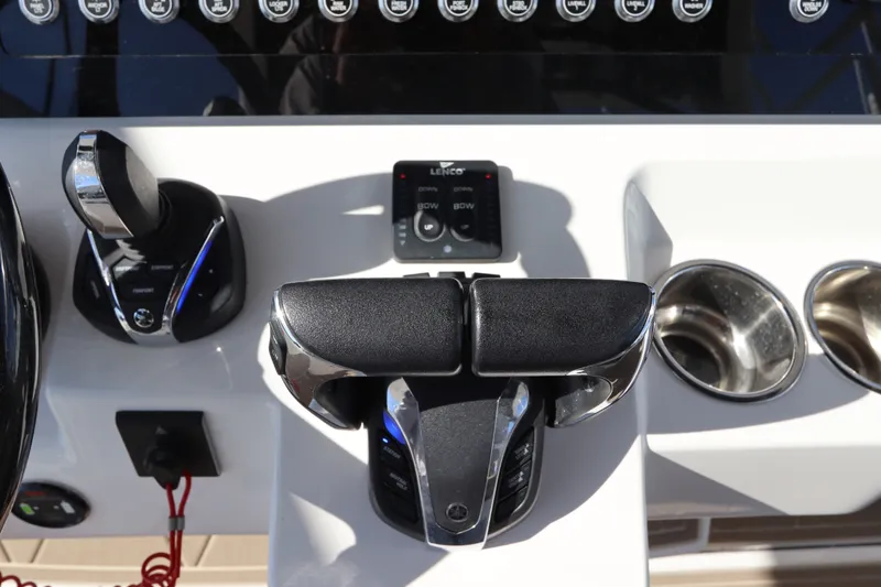 Slide: The Image of Control panel of 2021 Edgewater 370CC boat with throttle and cup holders. - 36